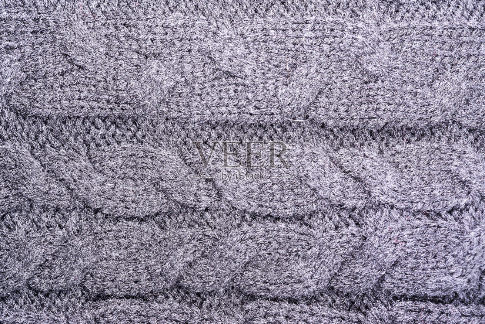 一種帶有辮子圖案、抽象背景的針織毛織品表面的紋理照片攝影