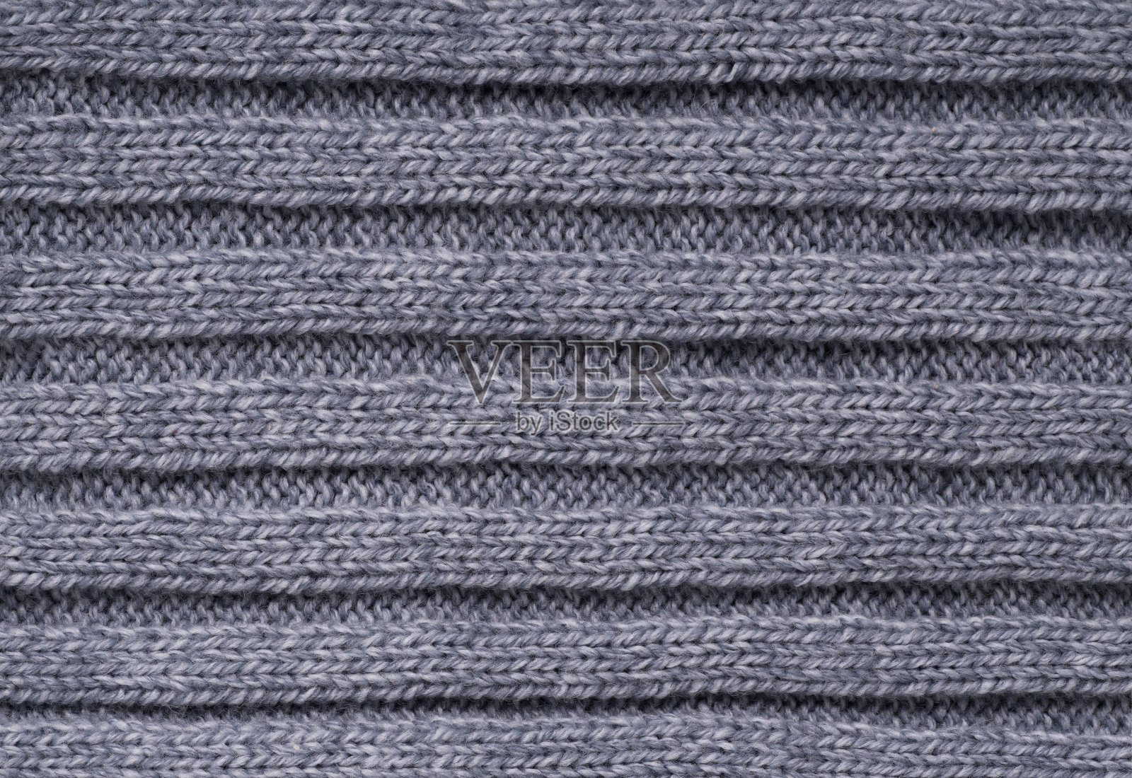 灰色針織毛織品的紋理。背景